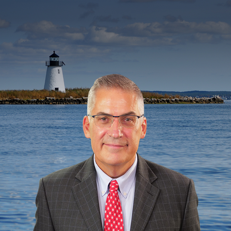 Attorney John C. Manoog, III with a lighthouse at the background